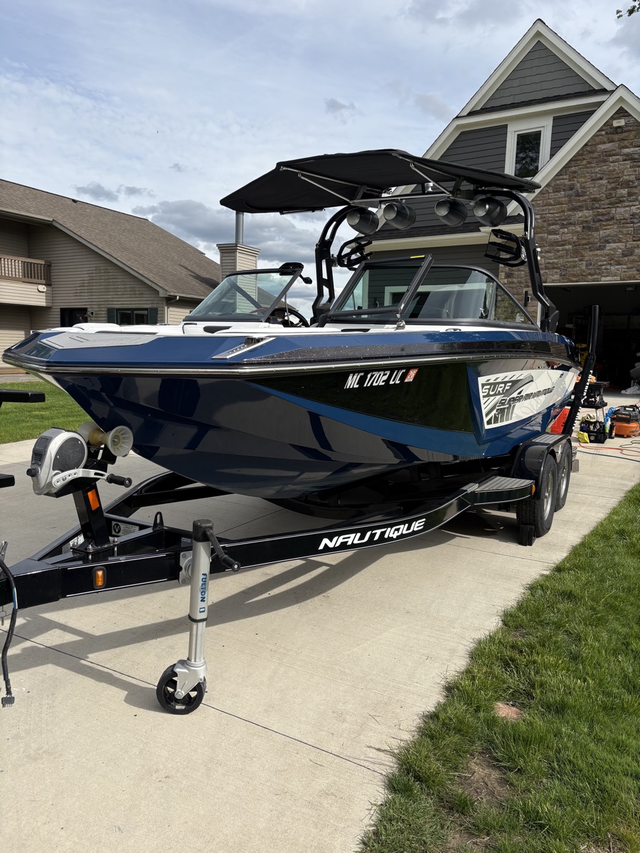 Freshly detailed wakeboard boat in a Michigan driveway