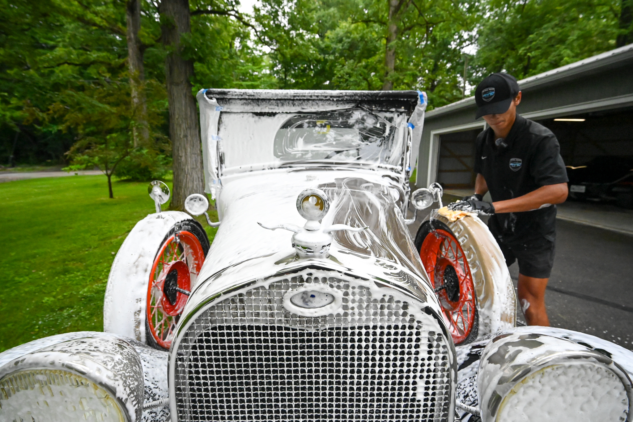 Classic car covered in foam during a wash