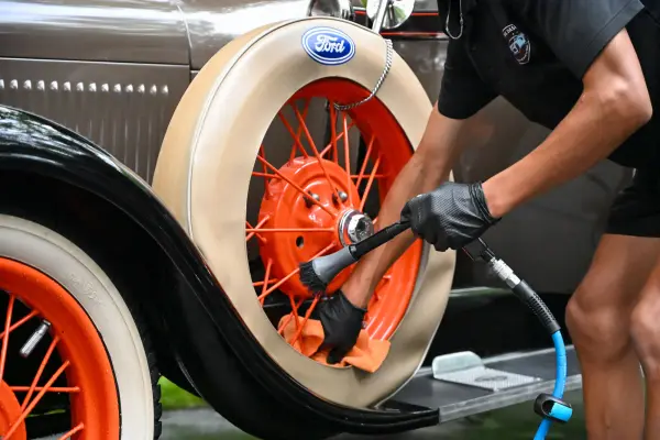 Cleaning the whitewall tire on a classic car