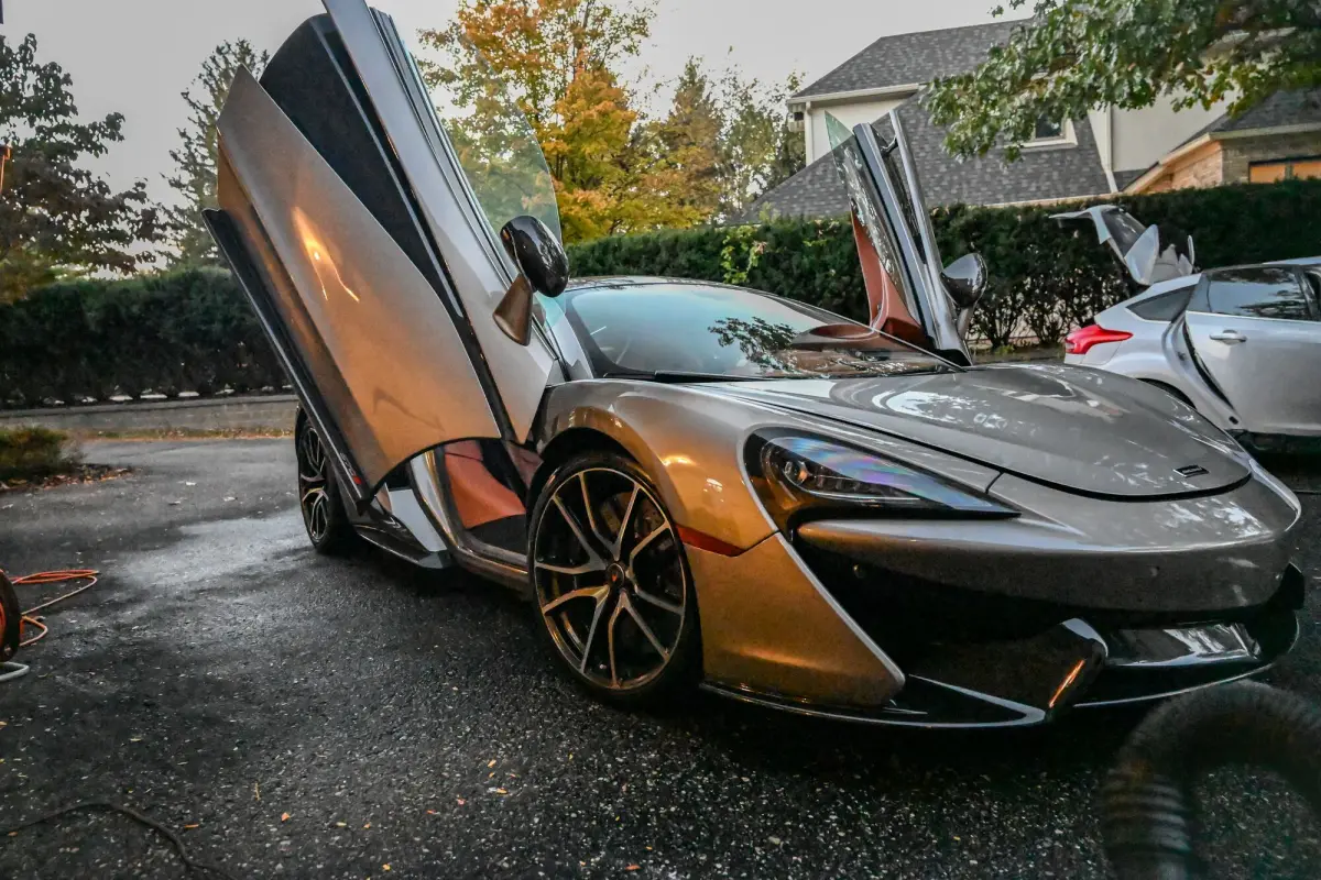 Finished McLaren with both doors up in the driveway