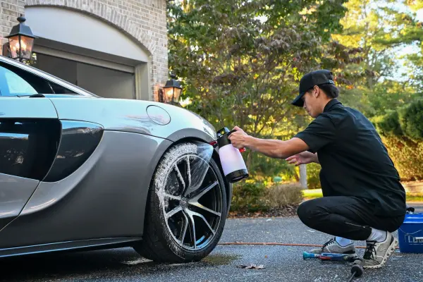Cleaning the front wheel of the McLaren