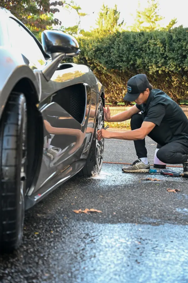 Cleaning around the McLaren wheel and brake caliper