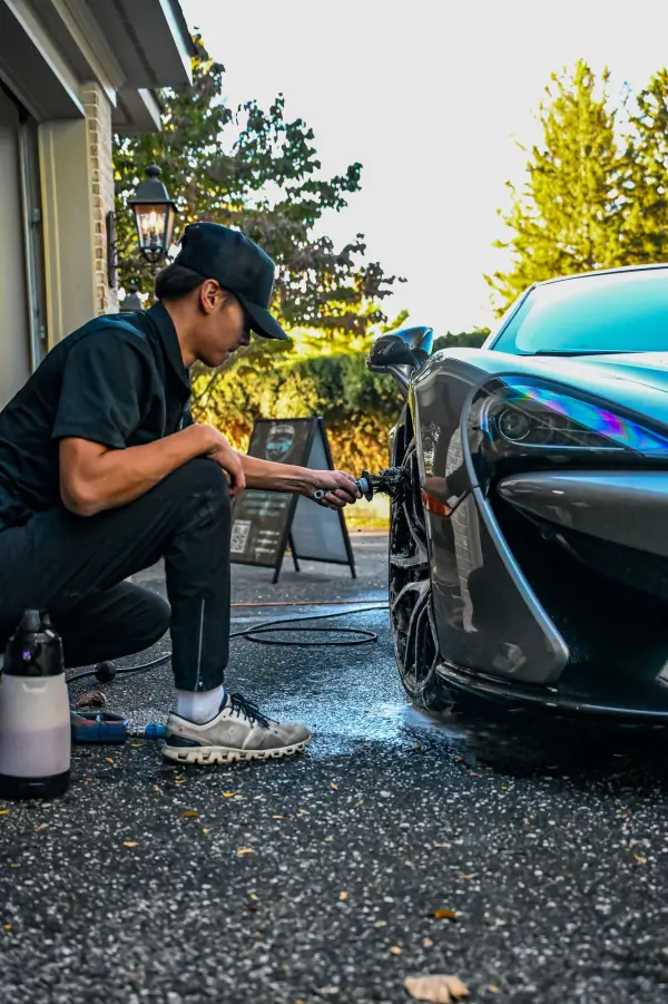 Kneeling at the McLaren wheel
