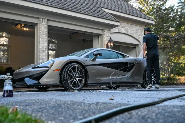 Washing the McLaren in the driveway